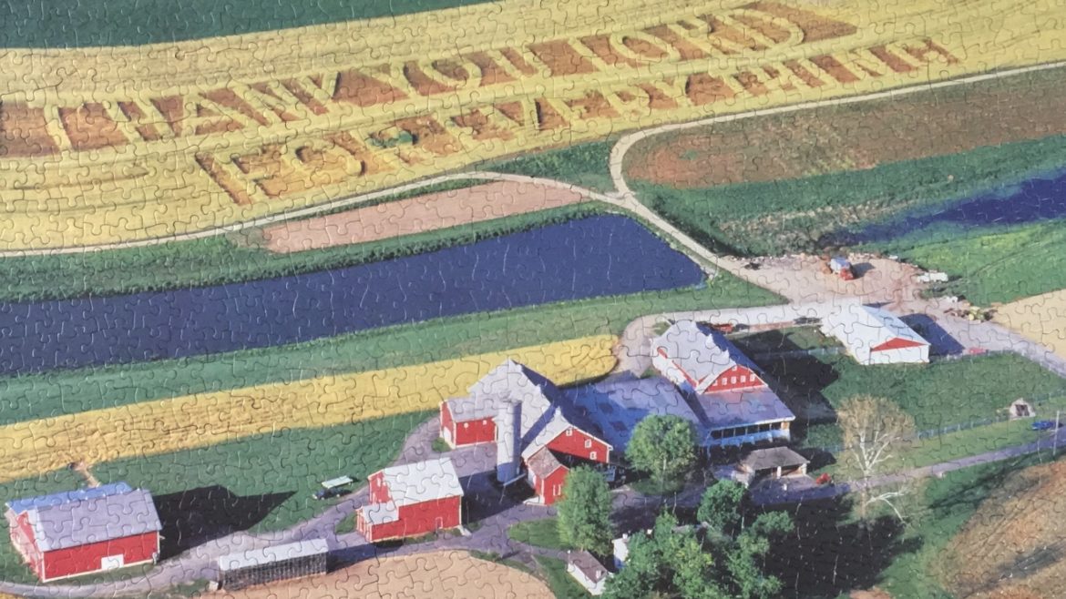 A completed puzzle of a farm landscape.