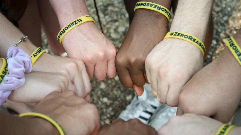 Supporters wearing Zero Reasons Why wrist bands.