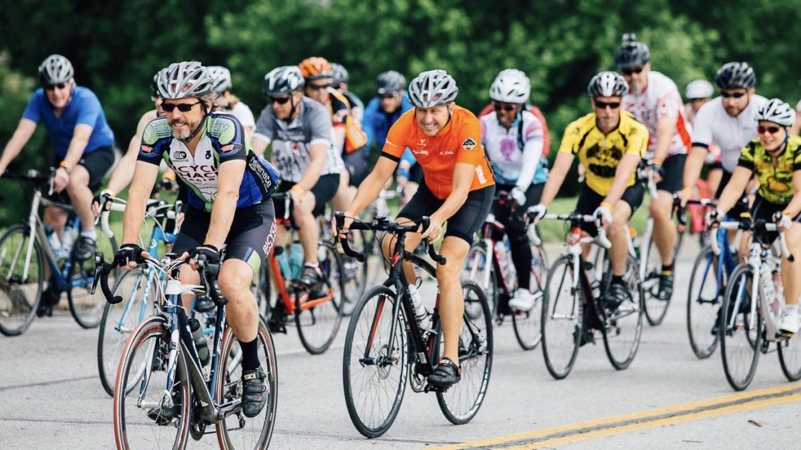 A group of cyclists ride in a pack.