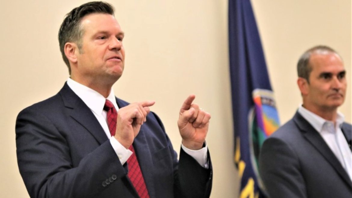 Kris Kobach and Bob Hamilton at a debate