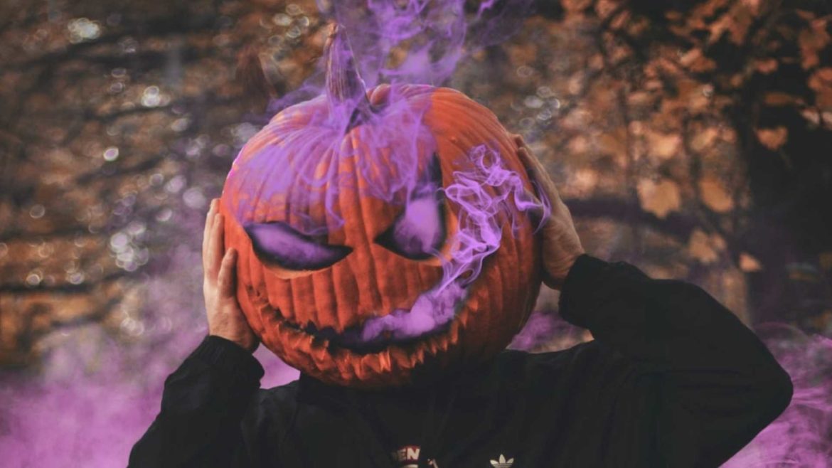 Halloween pumpkin head oozing purple smoke.