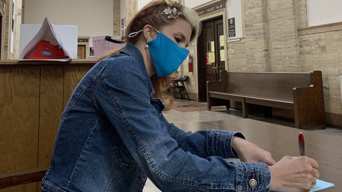 Stacy Welkom signing marriage documents.