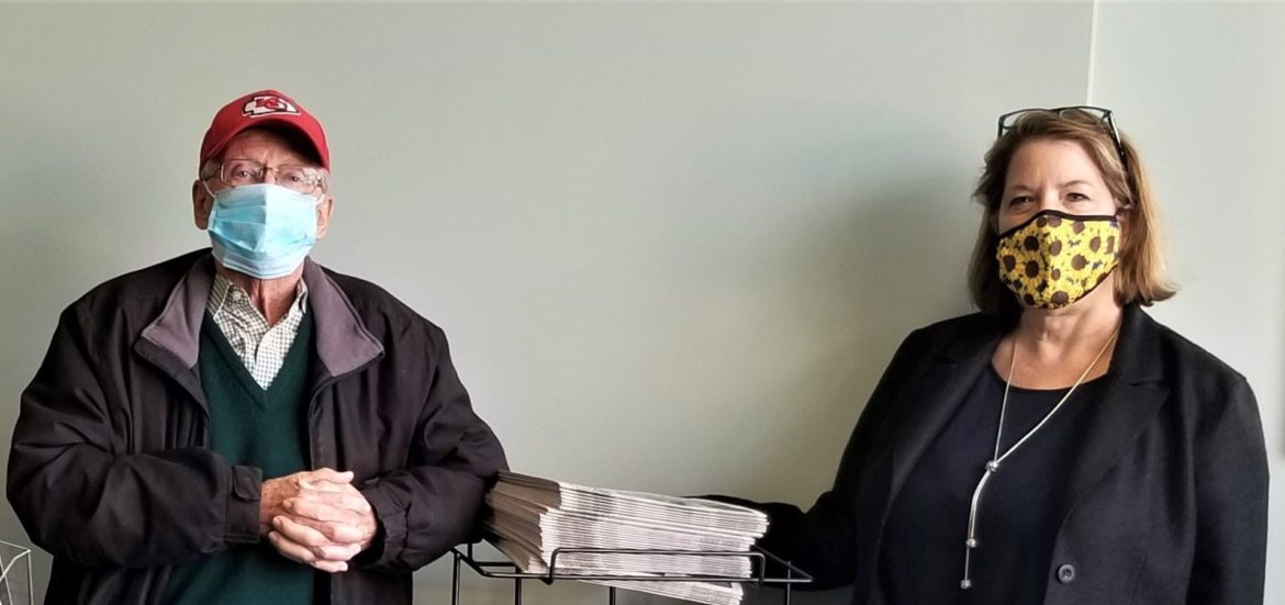 Sales director Dwight Barrett and publisher Kathy Feist in their newspaper office in Martin City.