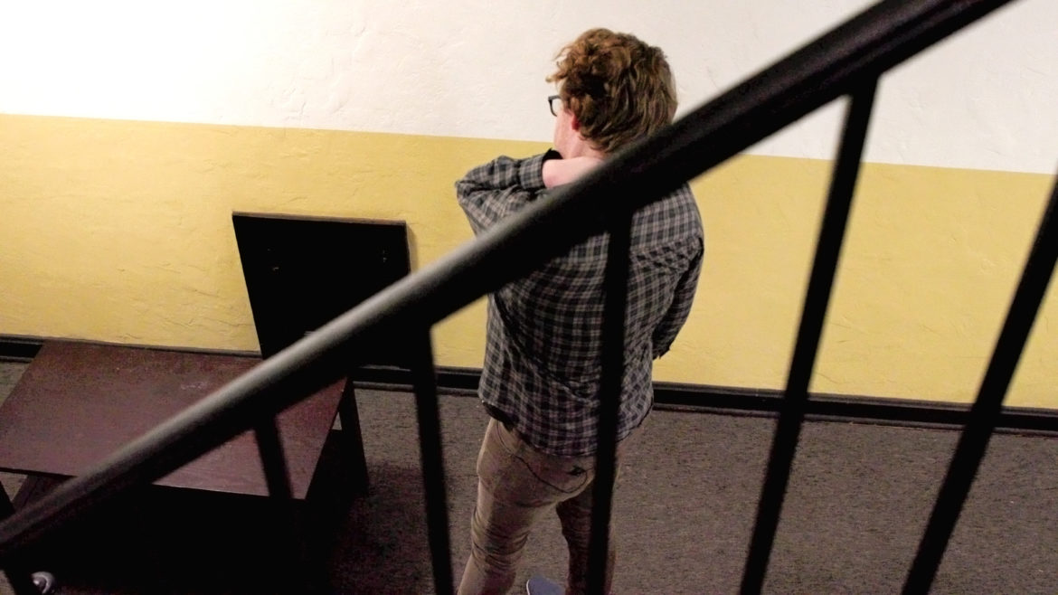 Kieran Vickers catches a breath after moving his furniture out of The Alps Apartments.