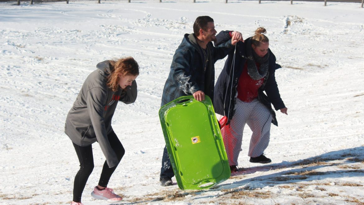 Despite the severe cold, families from around Lyon County gather Wednesday at the Prairie Street bridge hill in Emporia for sledding.