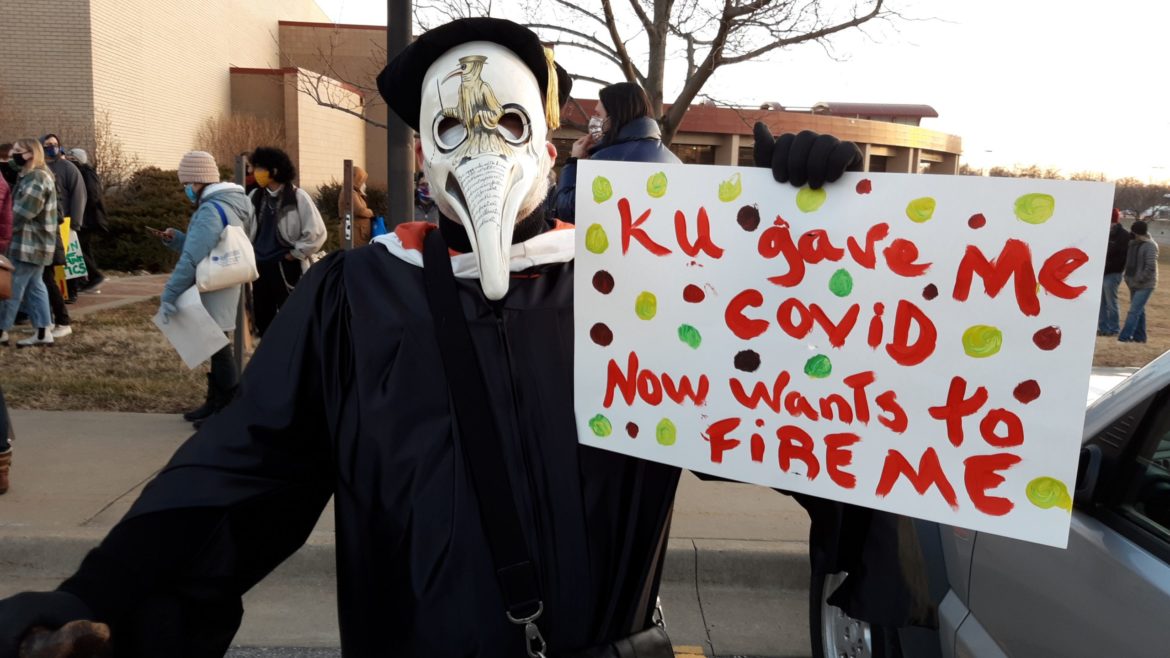 Gregory Cushman, an associate professor of environmental history at the University of Kansas, marched with faculty and students to raise awareness about potential damage of administration plans to downsize the staff and eliminate degree programs to address budget problems.