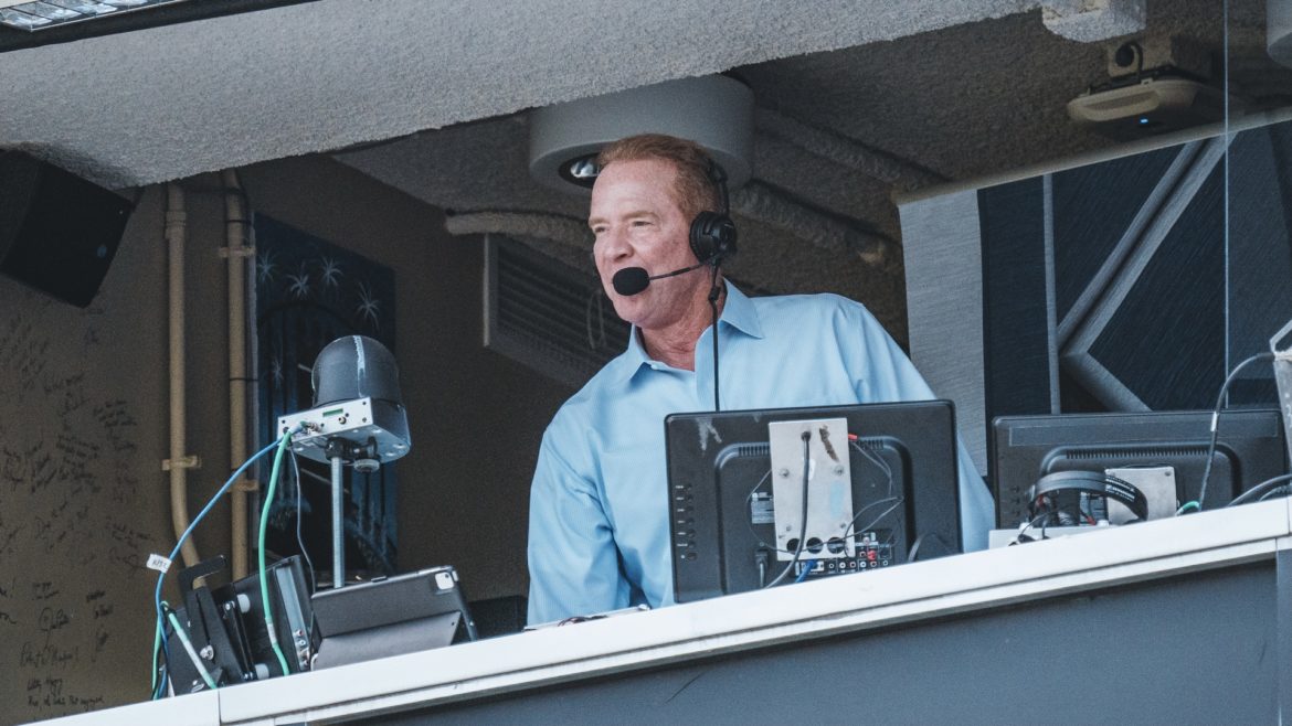 Rex Hudler making a call in the press box.