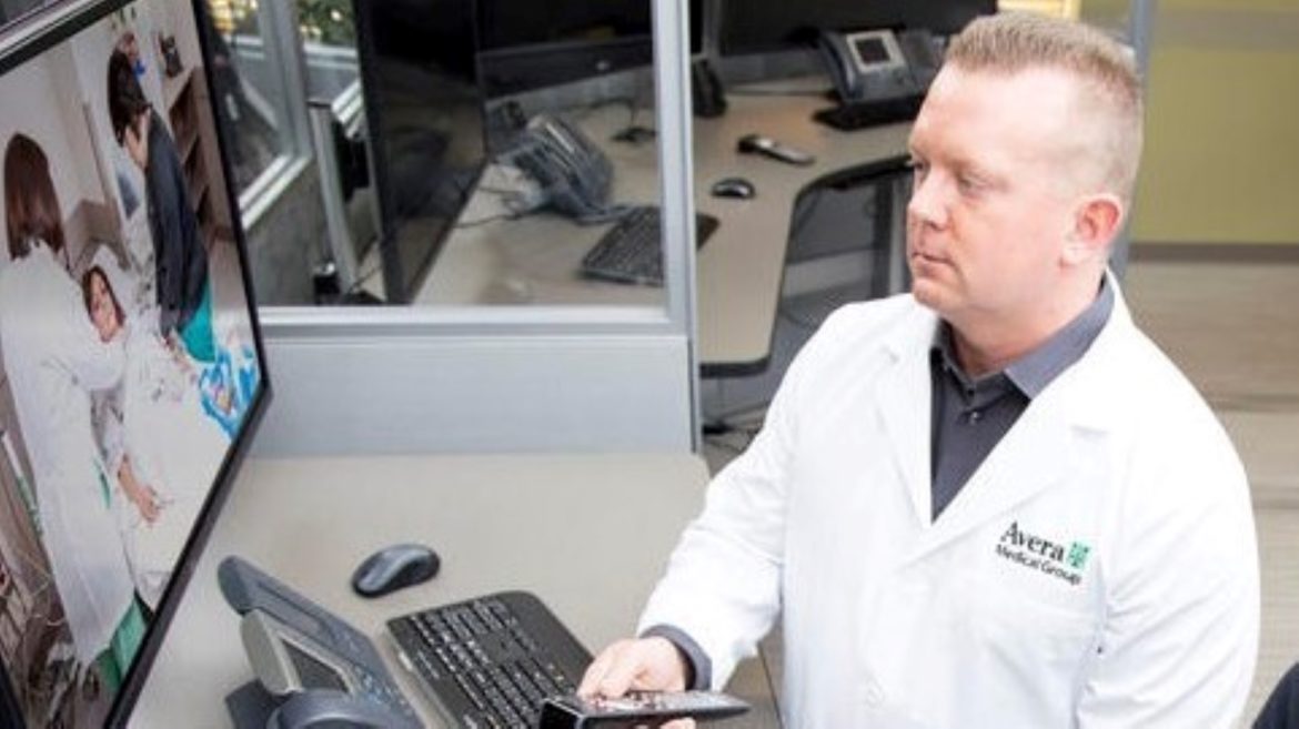 Brian Skow, an emergency room specialist, responds to a video call at Avera eCARE telemedicine center in Sioux Falls, South Dakota.