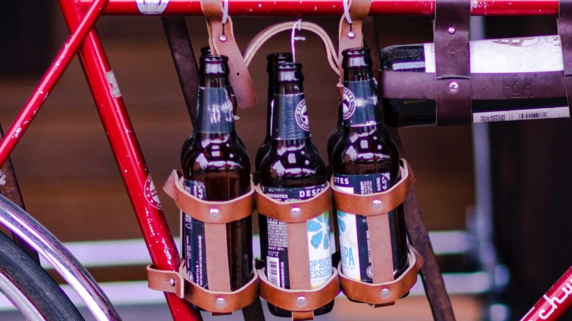 Beers dangling from a bicycle frame.