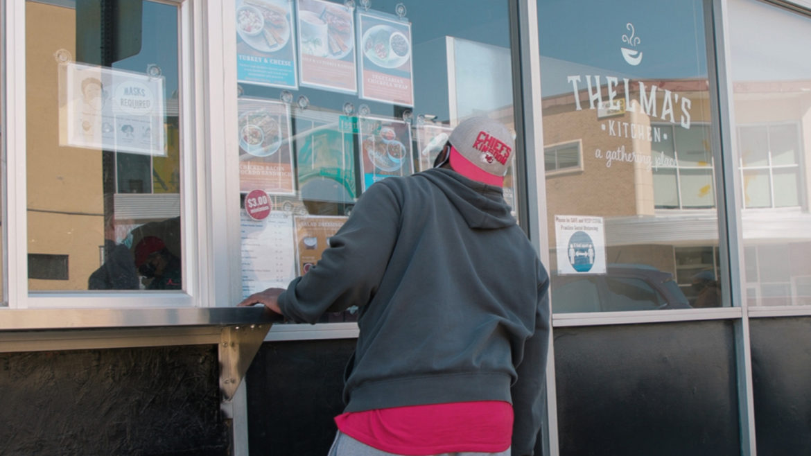 A customer selects food at Thelma's Kitchen.
