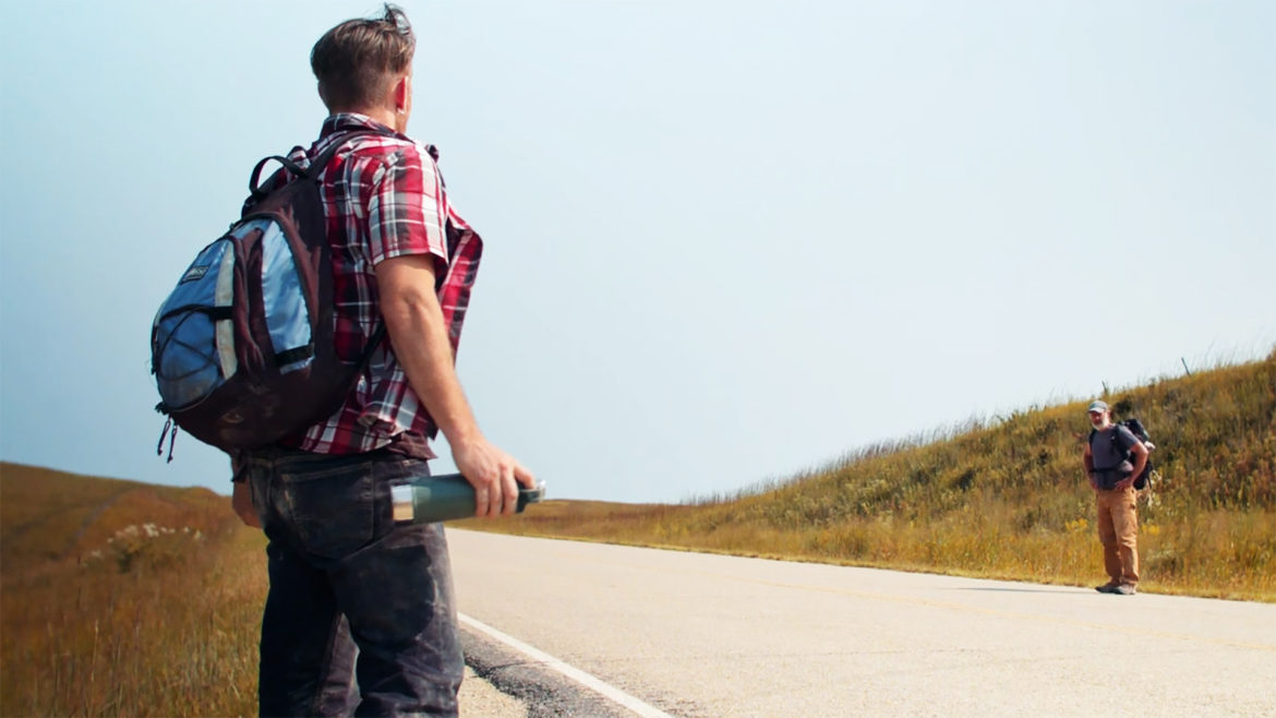 A scene showing to hitchhikers on a highway from "Found Wandering Lost,"