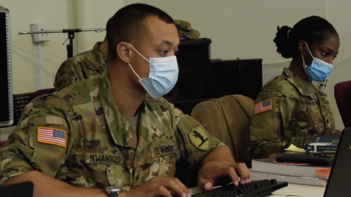 Sgt. Patrick Nwanguzo and Specialist Crystal Baddoo of the Missouri Army National Guard process Covid-19 vaccination information at the Morning Star/LINC vaccination clinic in Kansas City.