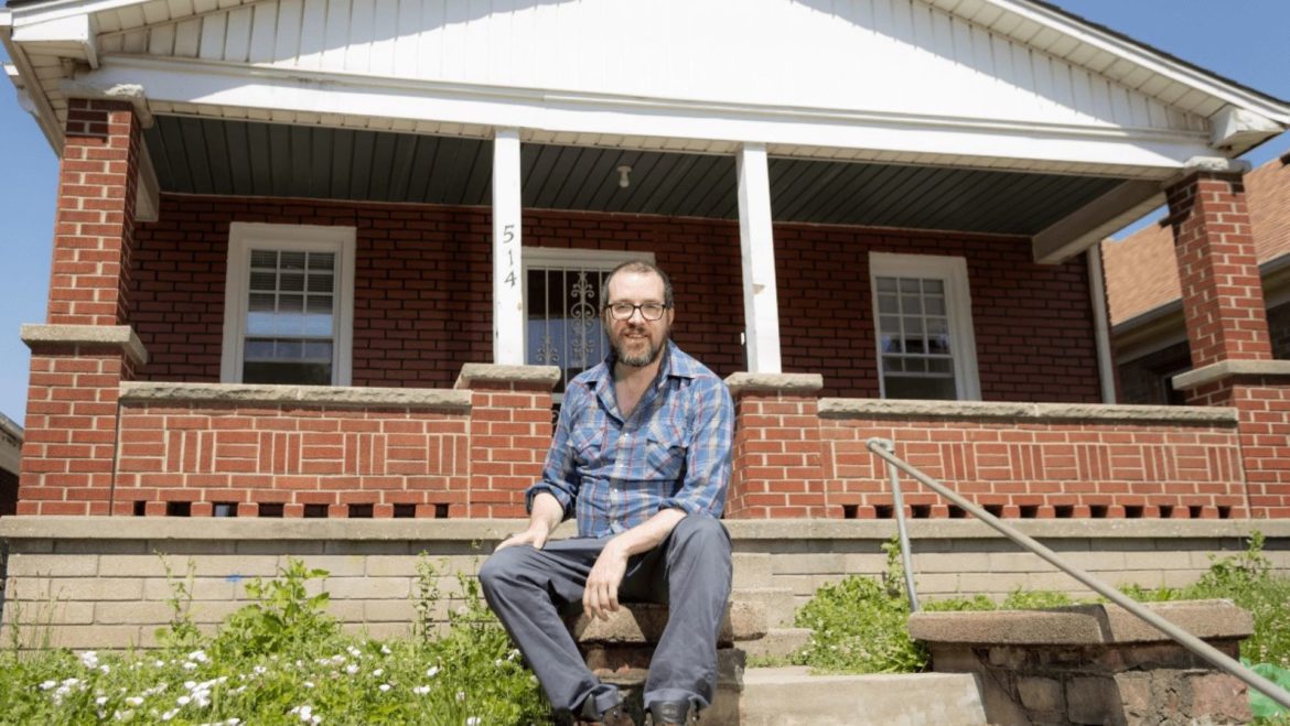 Travis Stull in front of his home in the Strawberry Hill neighborhood of Kansas City, Kansas. Stull bought his home in April.