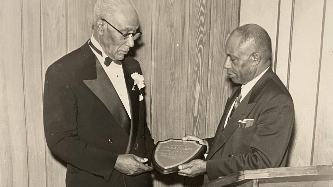 The Rev. D.A. Holmes (left) receiving an award.