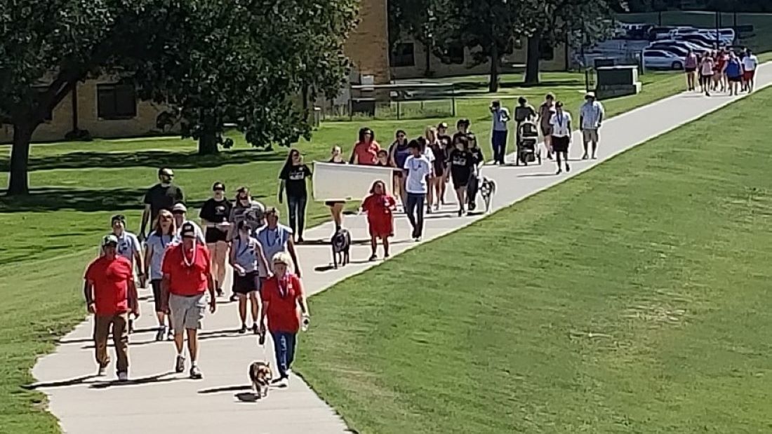 People gather for a suicide prevention and awareness walk in Hays in 2018.