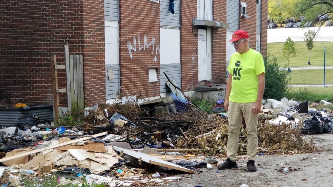 Dale Walker, president of the Blue Valley Neighborhood Association in Kansas City, surveys a trashed site near the intersection of 27th Terrace and Hardesty Avenue.