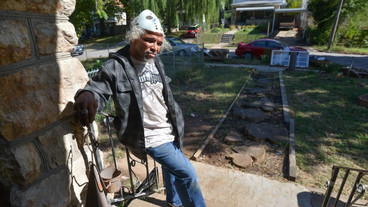 Kenneth Jenkins stands on his front porch along Montgall Avenue where he's been battling neighbors and city code enforcers.