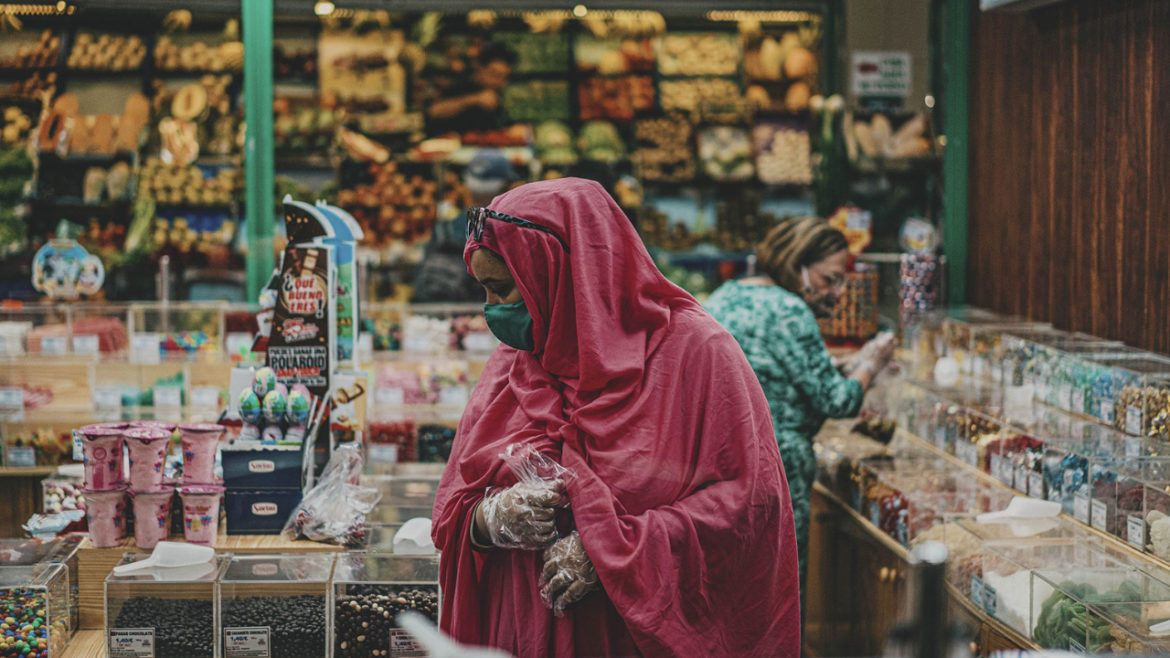 A woman shops in a farmer's market surround