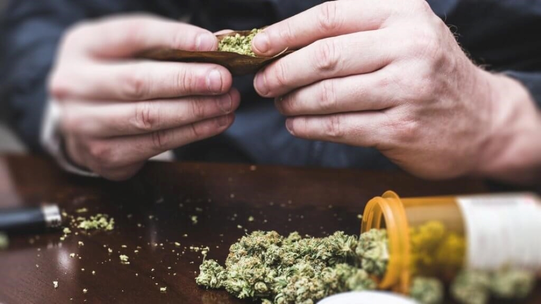 Man rolling a joint of medical marijuana.