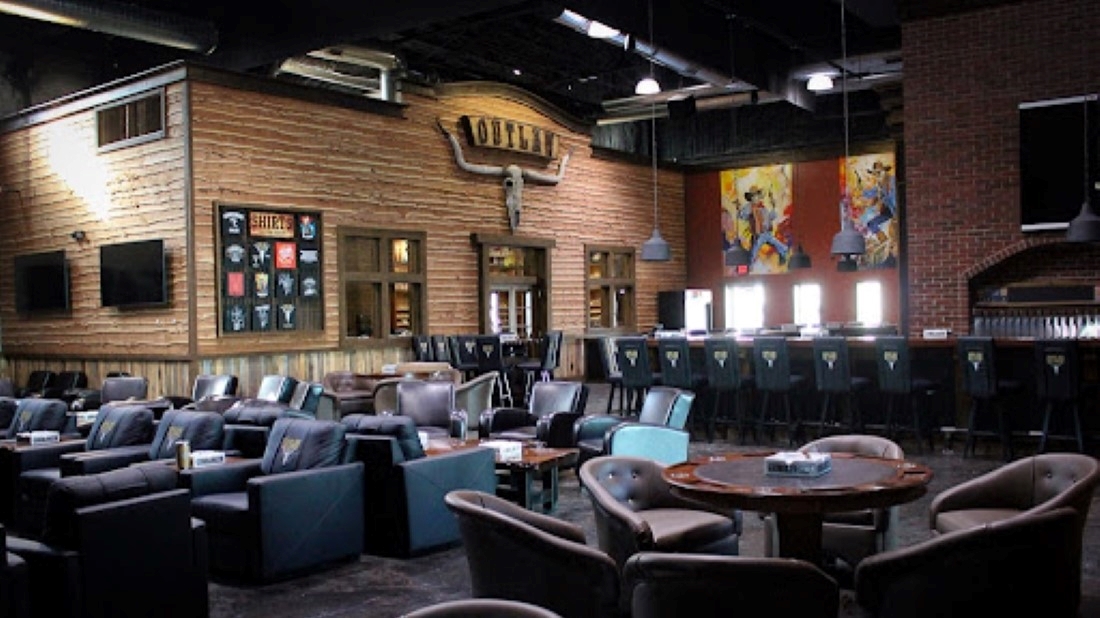 Interior view of seating and poker tables at Outlaw Cigar & Brewery.