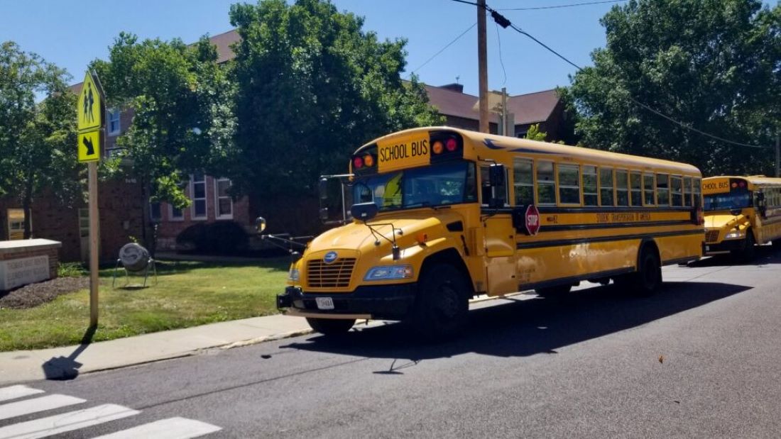 School buses wait Tuesday outside Thomas Hart Benton Elementary School in Columbia to take students home from the first day of classes.