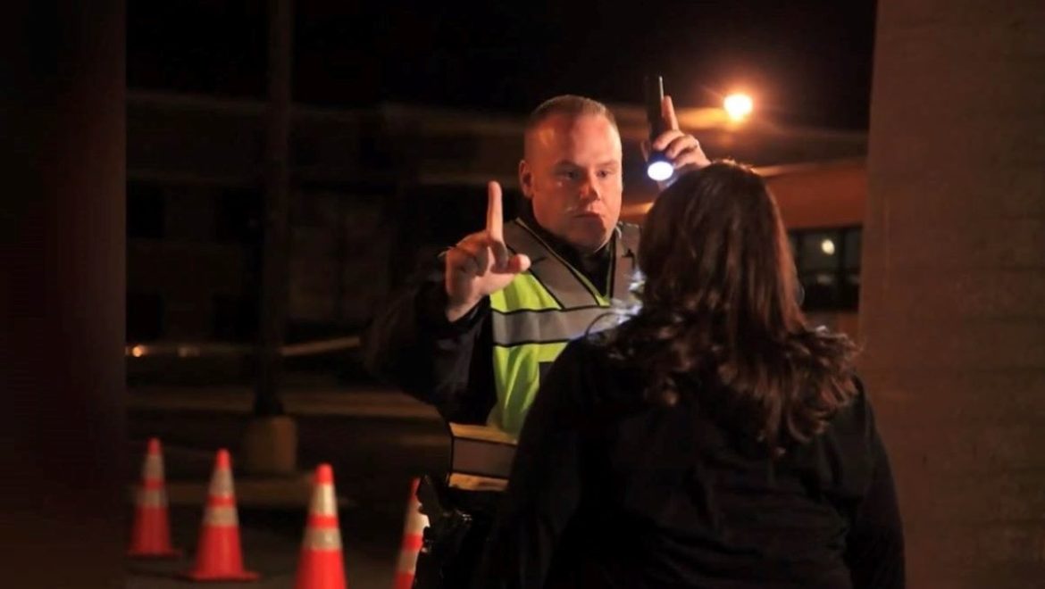 A Kansas City police officer administers a sobriety field test.