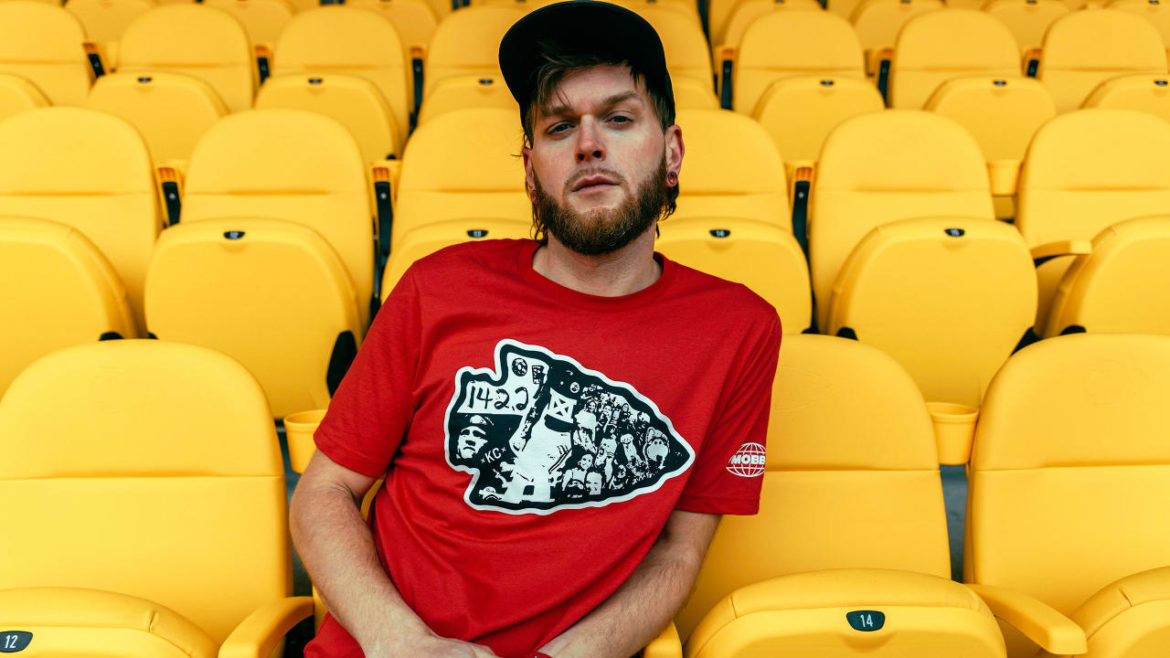 A fan posing in a MADE MOBB Chiefs t-shirt.