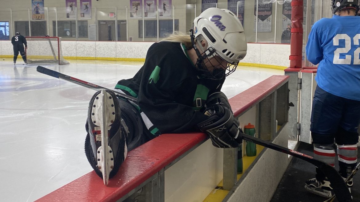 A KCWHL member stretches before taking the ice.