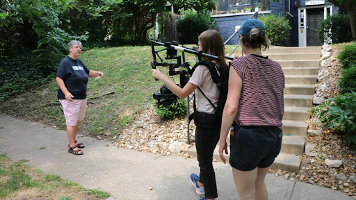 The Womontown documentary features co-founders Andrea Nedelsky and Mary Ann Hopper walking through their old neighborhood in Midtown Kansas City. Emily Woodring and Brydie O'Connor of Kansas City PBS film Nedelsky discussing Womontown's history.
