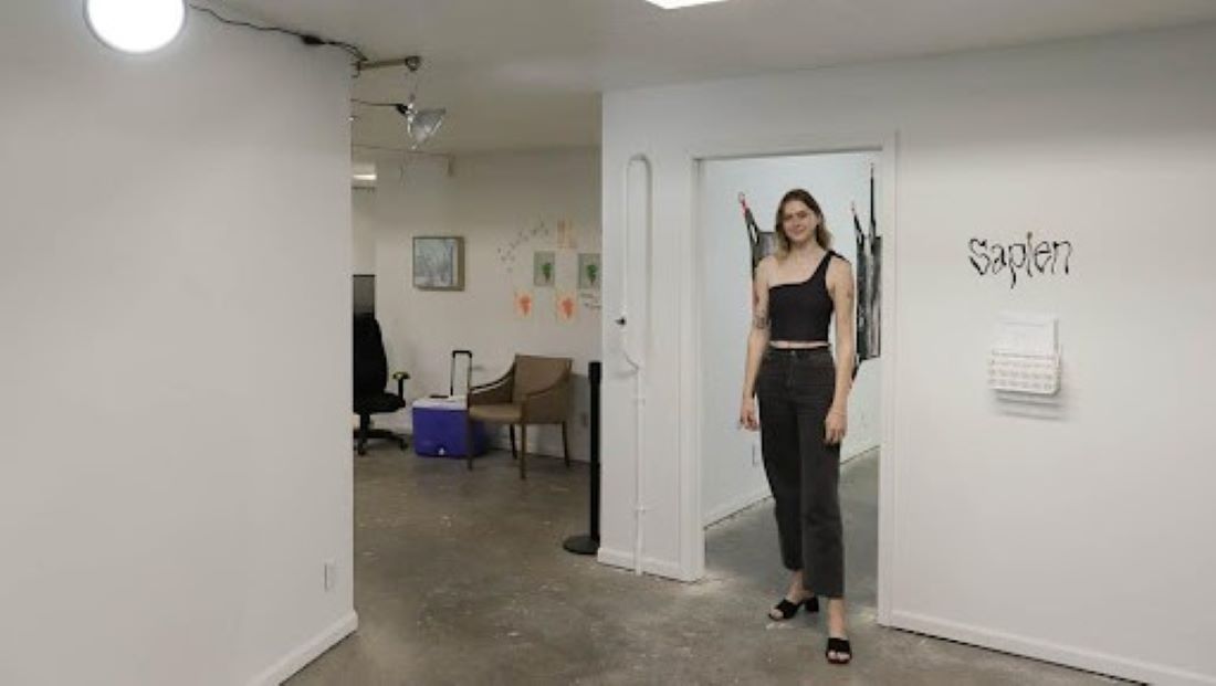 Co-curator RJ Junger stands in the foyer inside Sapien Gallery.