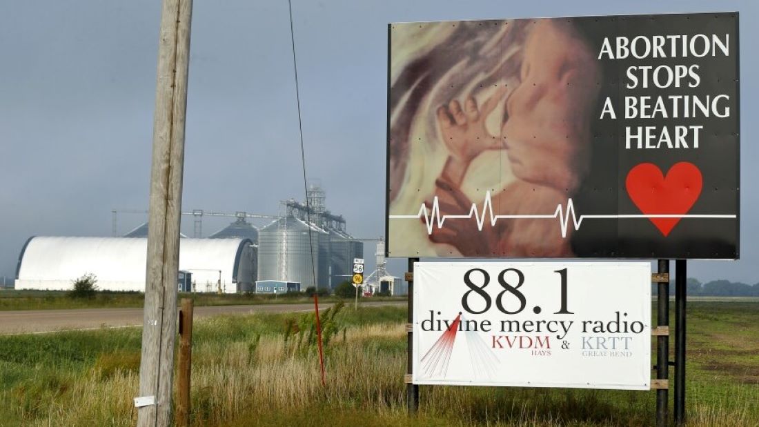 An anti-abortion sign next to a highway.