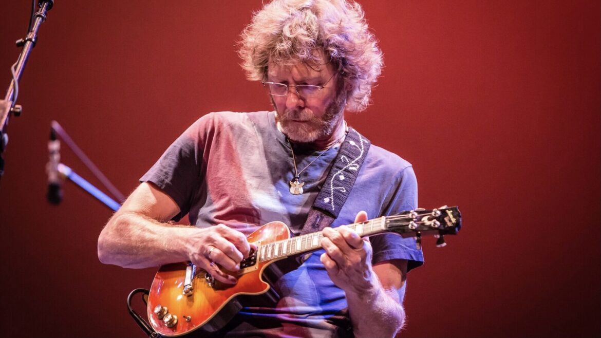 Bluegrass artist Sam Bush plays the mandolin on stage.