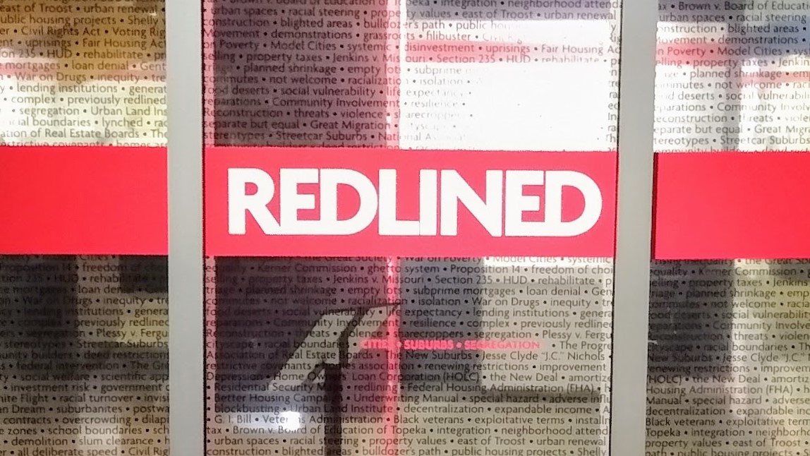 The doors to the Johnson County Museum exhibit: "Redlined: Cities, Suburbs, and Segregation."