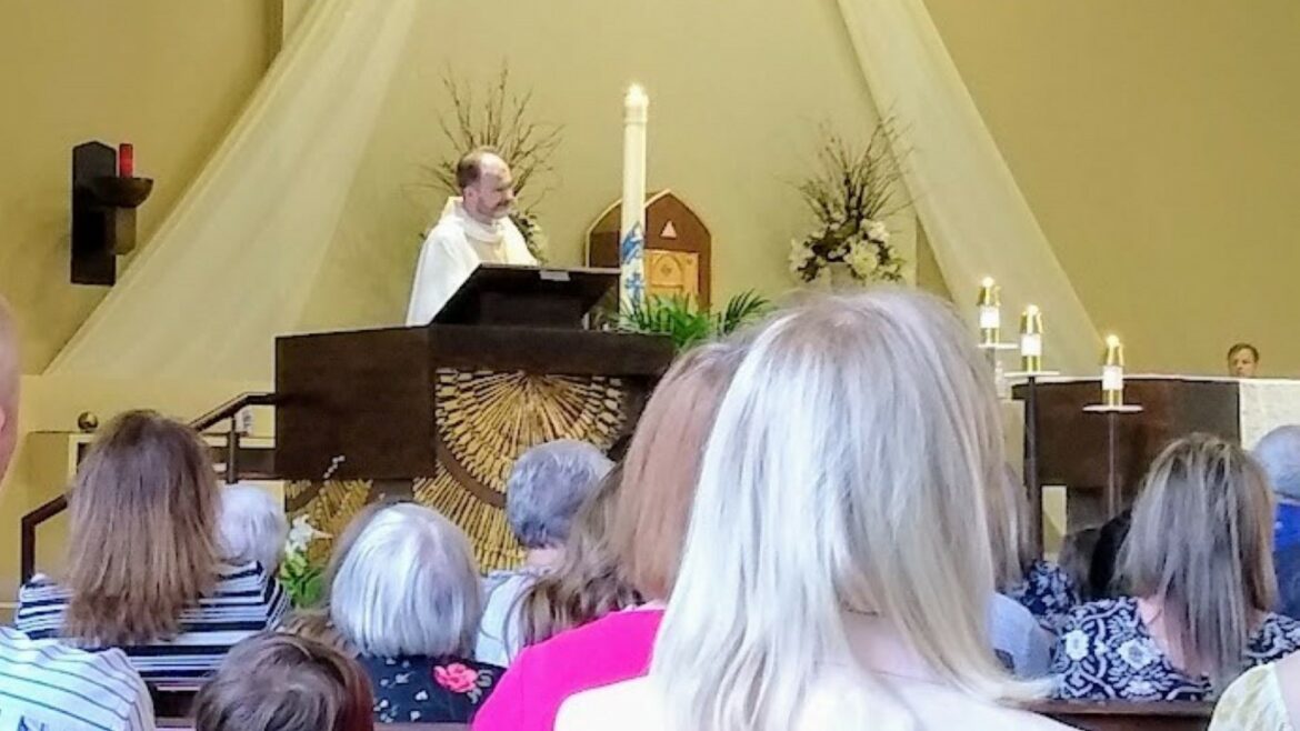 Fr. Justin Hoye presides at the altar of St. Thomas More Catholic Church at this year’s Easter Vigil service.