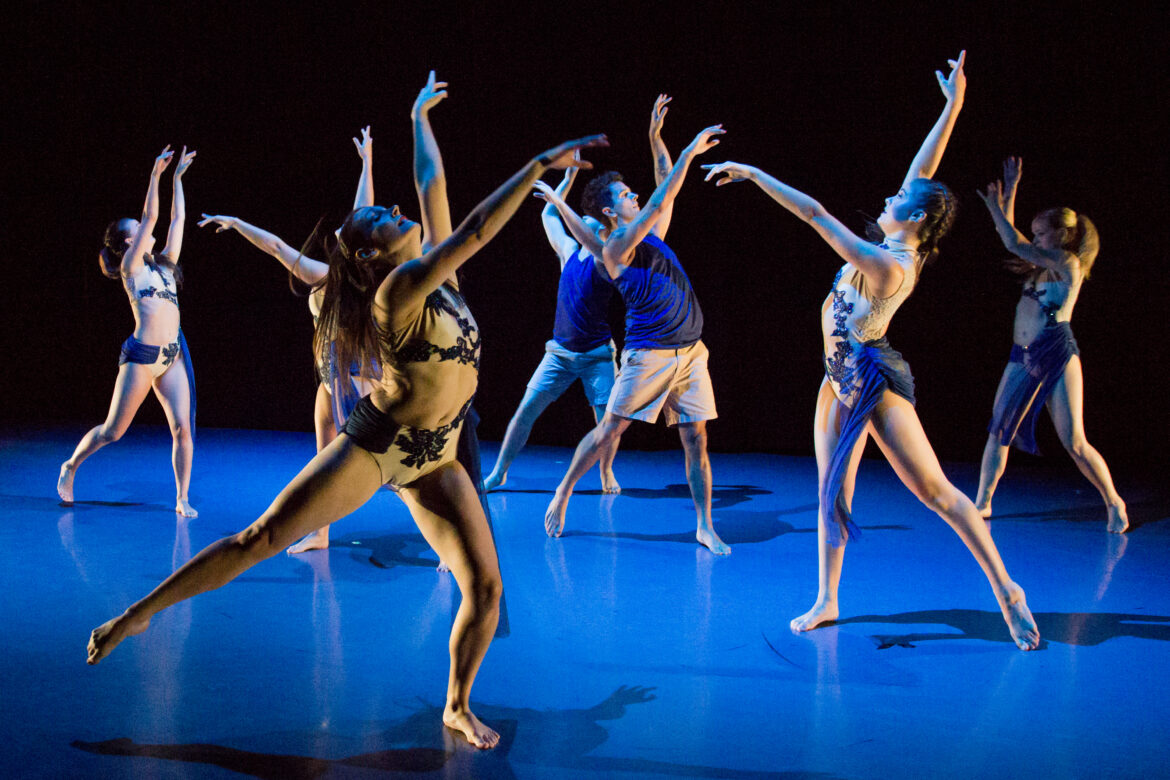 Dancers perform on stage.
