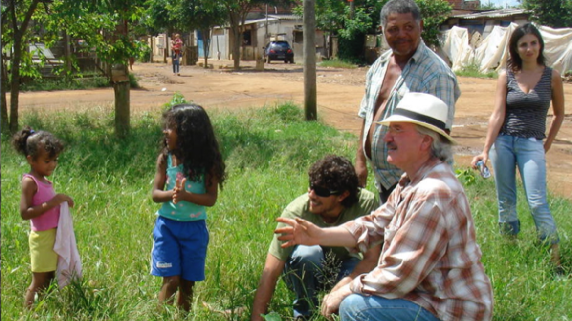 Kansas artist Stan Herd working with area youth and others on one of his prior trips to Brazil's favelas.