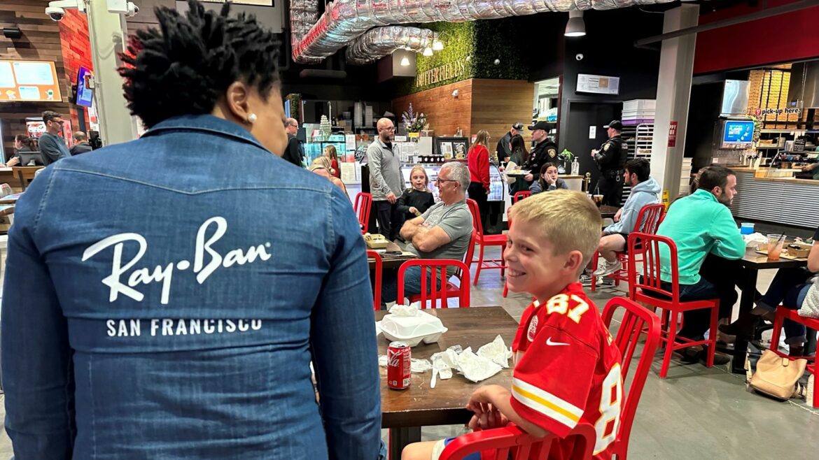 Odin Smith of Lenexa shares a smile with Stella Musongong, who owns African Dream Cuisine with her husband Neba Ngwa. It was Odin’s first time dining at the food stall in Lenexa Public Market.