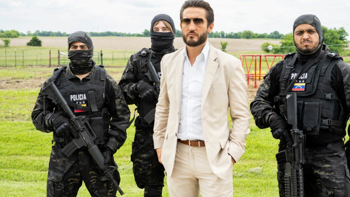 A scene from the film "The Unexpected" depicting a man in a white suit accompanied by three men in combat gear carrying weapons.