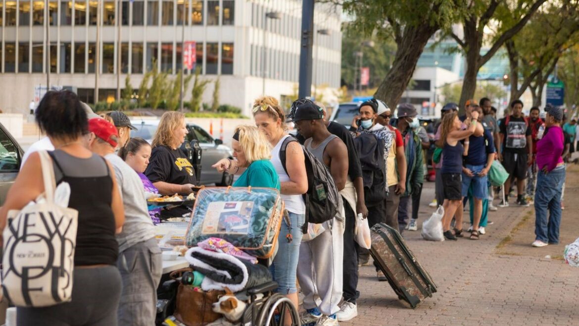 Members of Kansas City Heroes, a local nonprofit, serving a free meal to unhoused individuals on Oct. 4. The organization hosts this dinner every Tuesday in Washington Square Park.