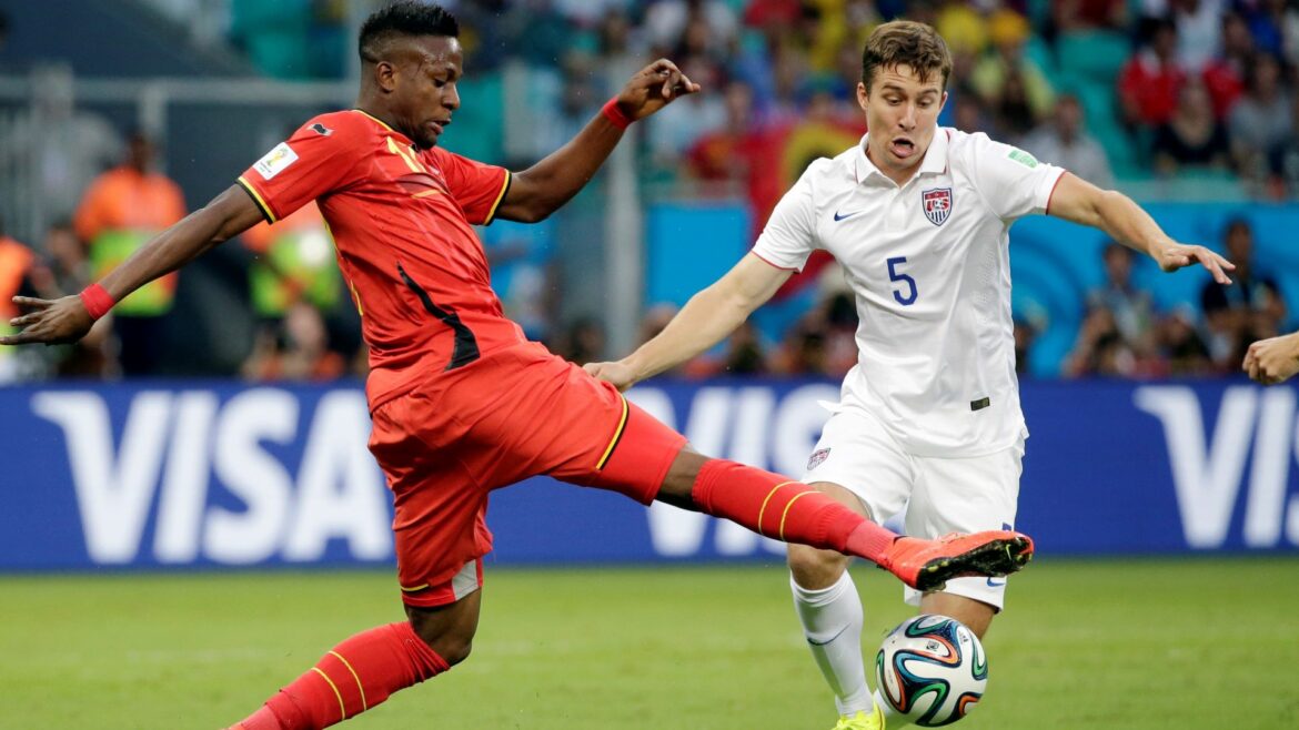 Belgium's Divock Origi, left, fights for the ball with United States' Matt Besler (5) during the World Cup round of 16 soccer match between Belgium and the USA at the Arena Fonte Nova in Salvador, Brazil, Tuesday, July 1, 2014.