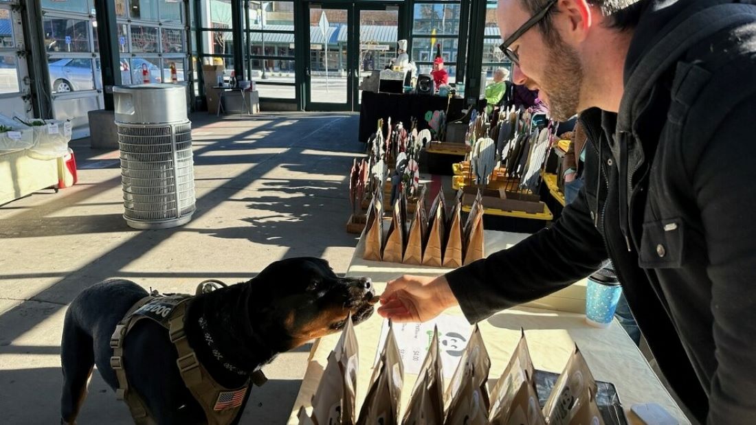 Older Youth Case Manager Joe Brecht shares samples of reTreats gourmet dog treats at The City Market on a Sunday morning.