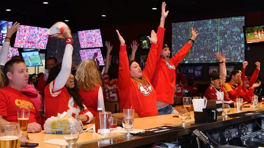Fans at Buffalo Wild Wings in Independence, Missouri, celebrate during last year's AFC championship between the Chiefs and Bengals. Fans showed up hours before the game, sporting Chiefs merchandise and downing food and drink.