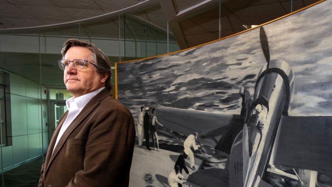 Mark Spencer, new arts program coordinator for the Kansas City Aviation Department, with “Tingmissartoq,” by Christopher Brown (shown behind him), created in 2000 for the KC Aviation Department building.