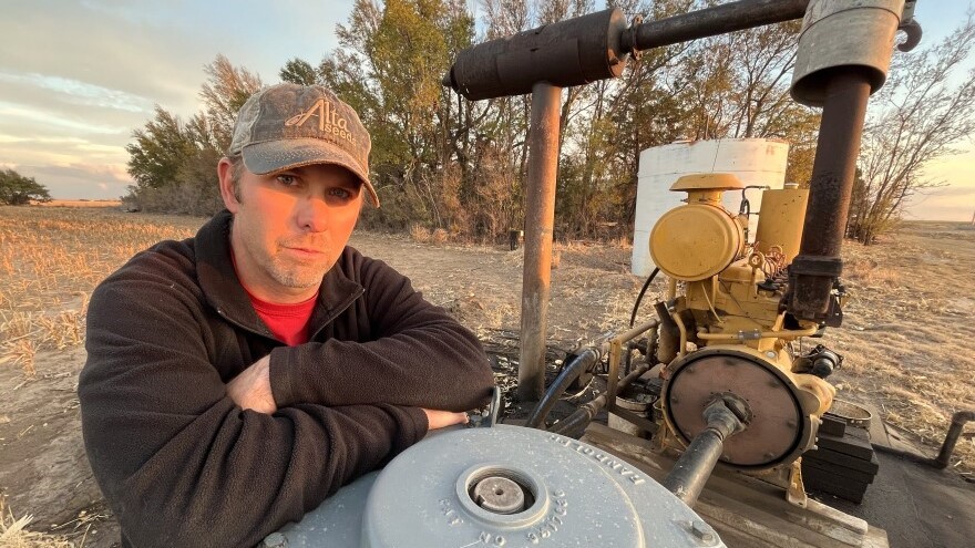 Haskell County farmer Travis Leonard stands next to his well that finally gave out this year. It's one of several that have run out of water on his farm in southwest Kansas in recent years as the Ogallala aquifer declines.