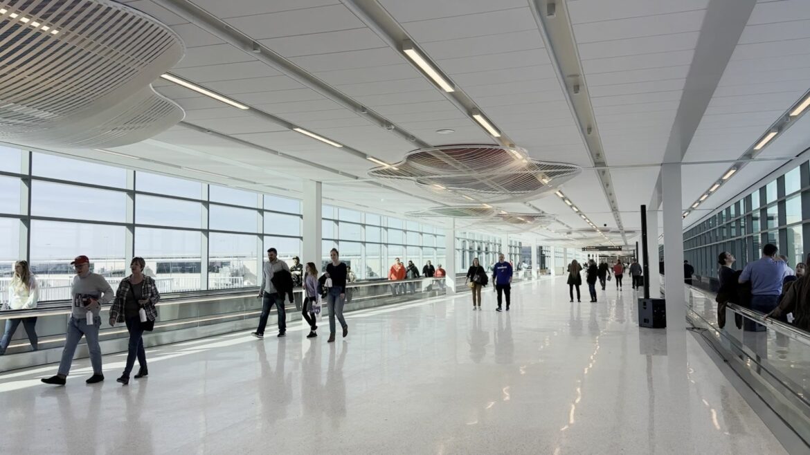 People use the moving sidewalks at the new Kansas City International Airport terminal.