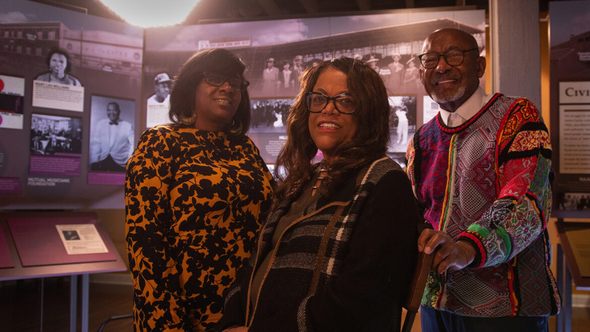 Two Black women and man at museum