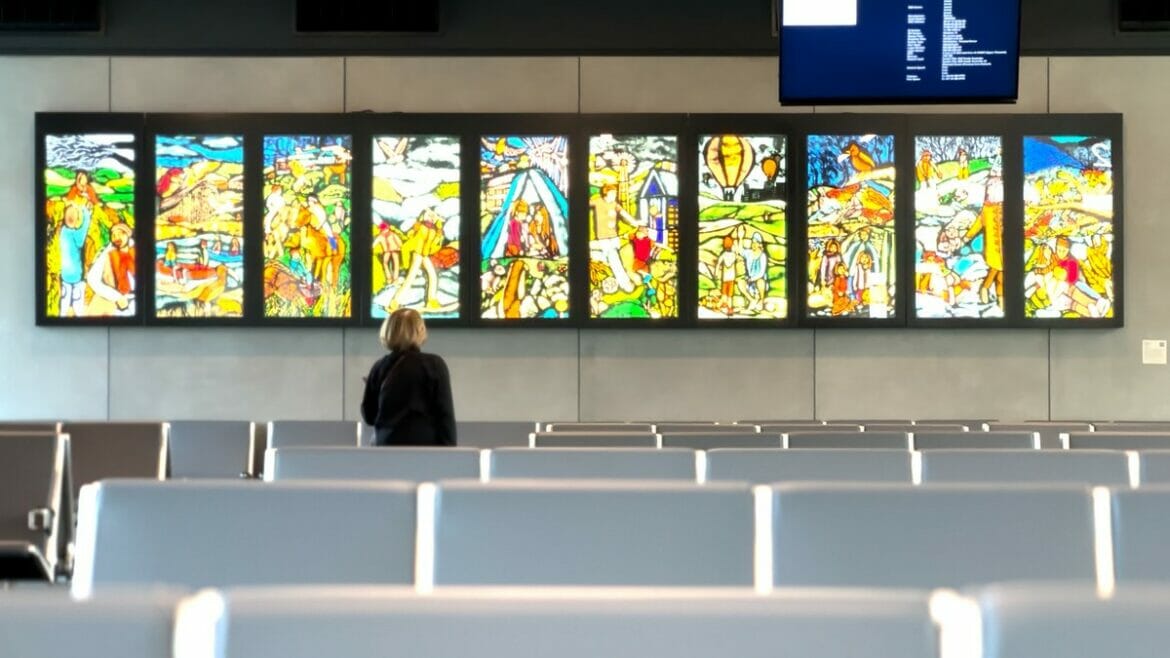 A traveler viewing panels of art at the new Kansas City International Airport.