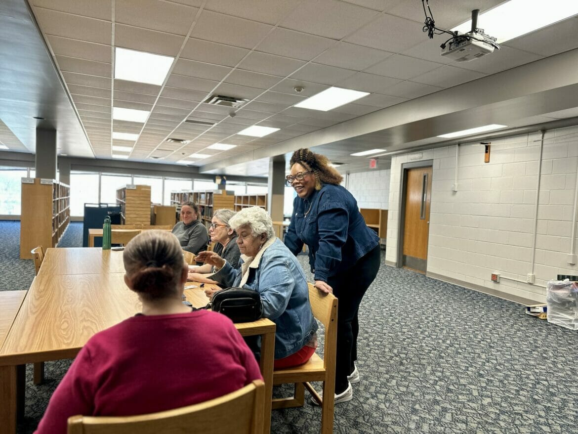 A crowd surrounds Kim Riley, parent and founder of the Transition Academy. For the past several years, her focus has been to build a network that better assists families whose children have developmental or intellectual disabilities find meaningful careers.