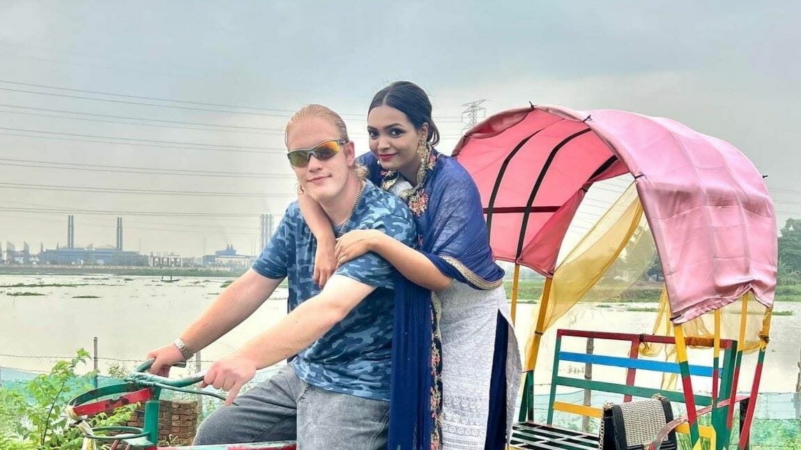Ryan Coffman and Sayeeda Islam in a traditional Bangladeshi three-wheeled passenger cart.