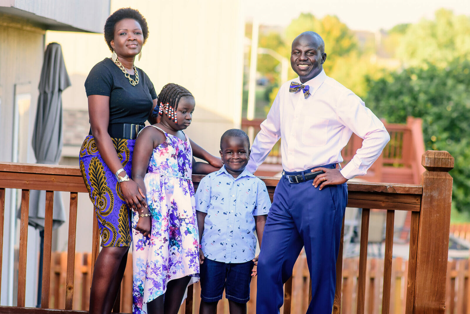 A family picture, outside on a wooden deck. In the 1990s, Denis Kweri was a young 20-something fleeing from the second Sudanese Civil War. He and his family made their way to Kansas City where he says he found a home and hope. Now he wants to pay it forward. (Contributed)